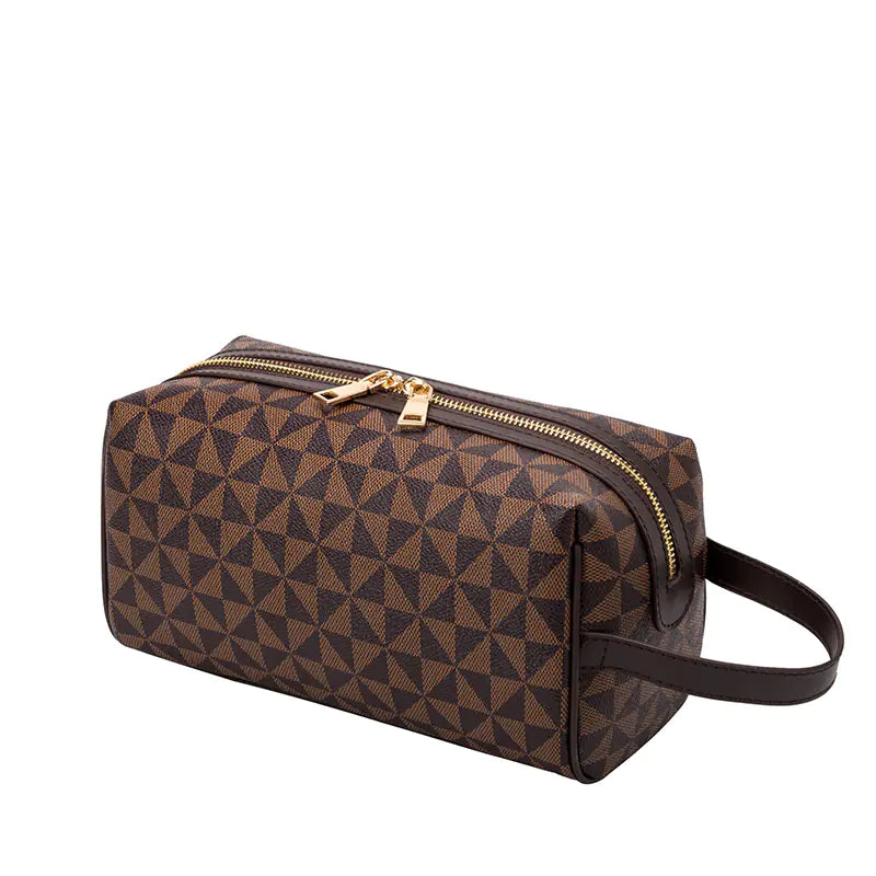 Brown geometric patterned toiletry bag with gold zipper on a white background